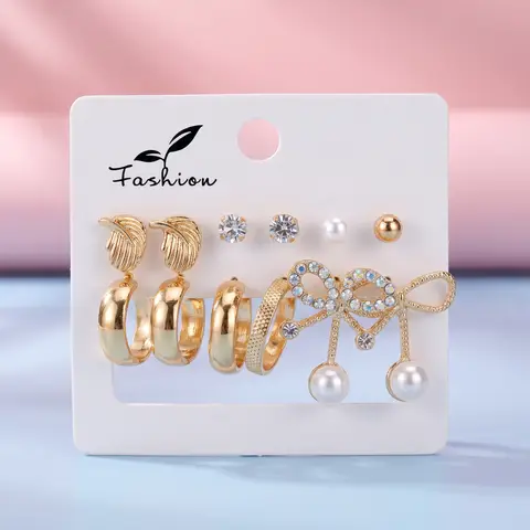 Set de 9 pares de aretes dorados con cristales y diseños variados